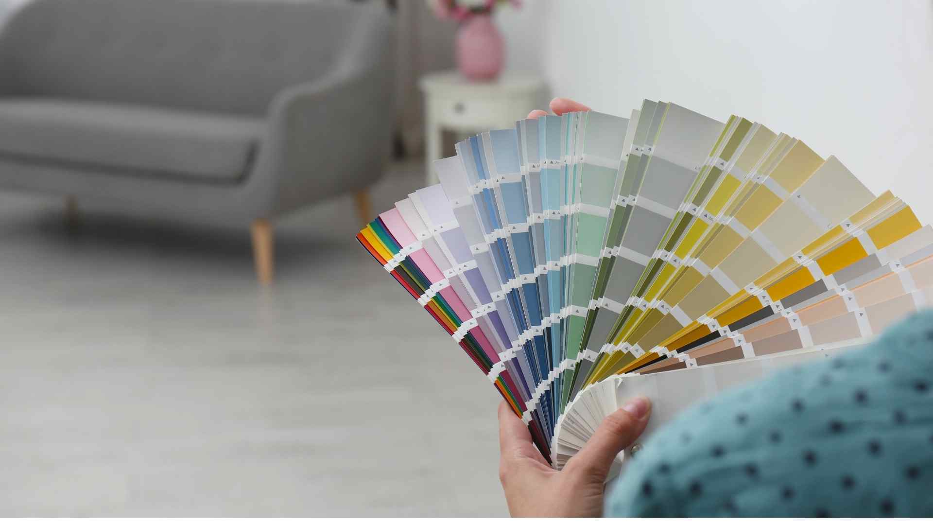 Person holding up color swatch displaying multiple color options