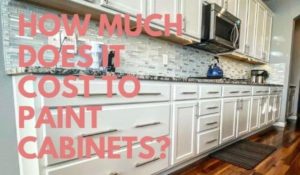 Image of freshly painted white kitchen cabinets w/title: how much does it cost to paint kitchen cabinets