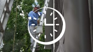 image of painter painting an exterior with a graphic of a clock overlayed