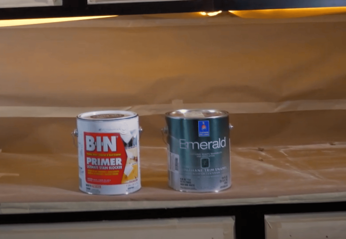 Image of bin shellac primer can next to Sherwin Williams Emerald Urethane paint
