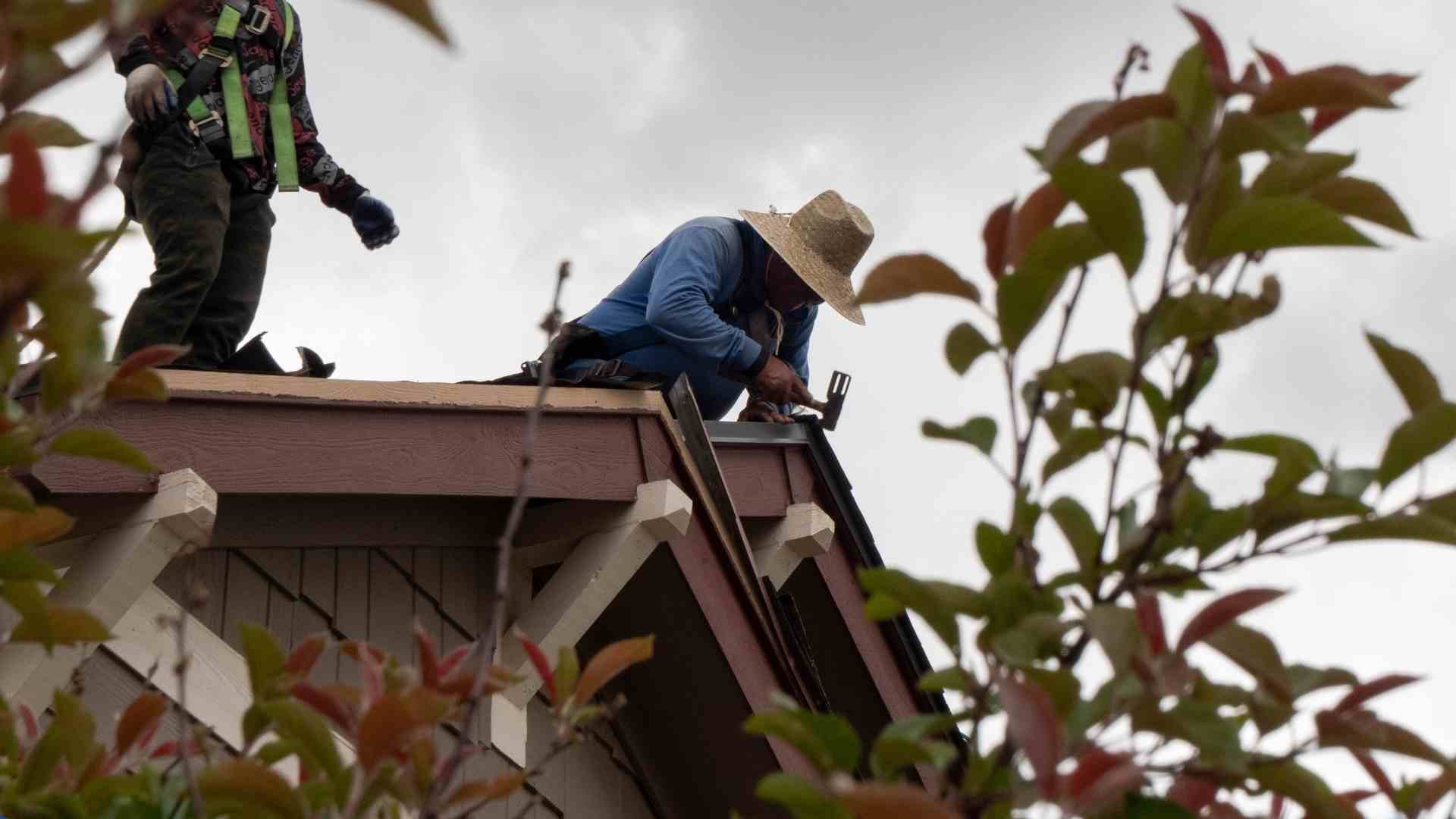 a roofer pulling up roof