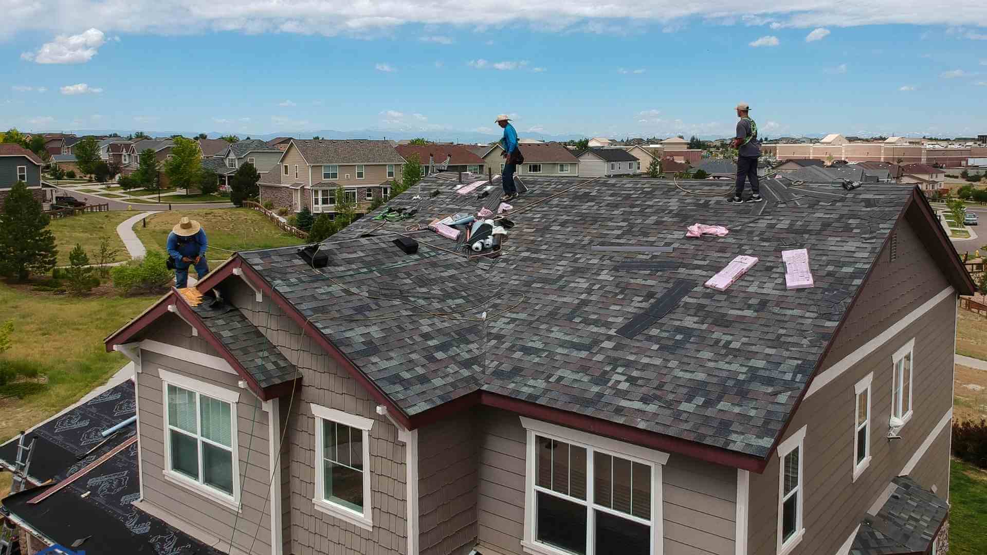aerial shot of roofers redoing a roof