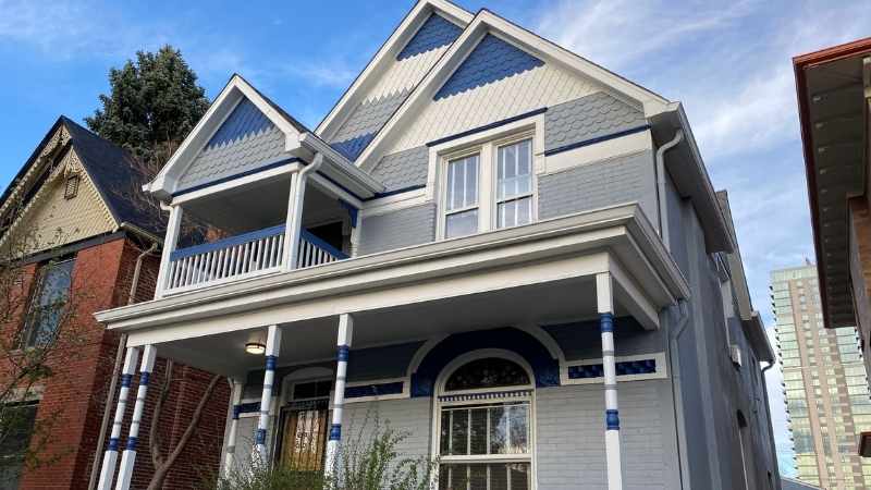 Photo of a gray and blue victorian exterior painted by kind home solutions