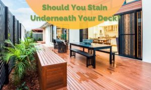 Article thumbnail with image of a nicely stained deck and title reading: Should you stain underneath your deck in greed bold letters