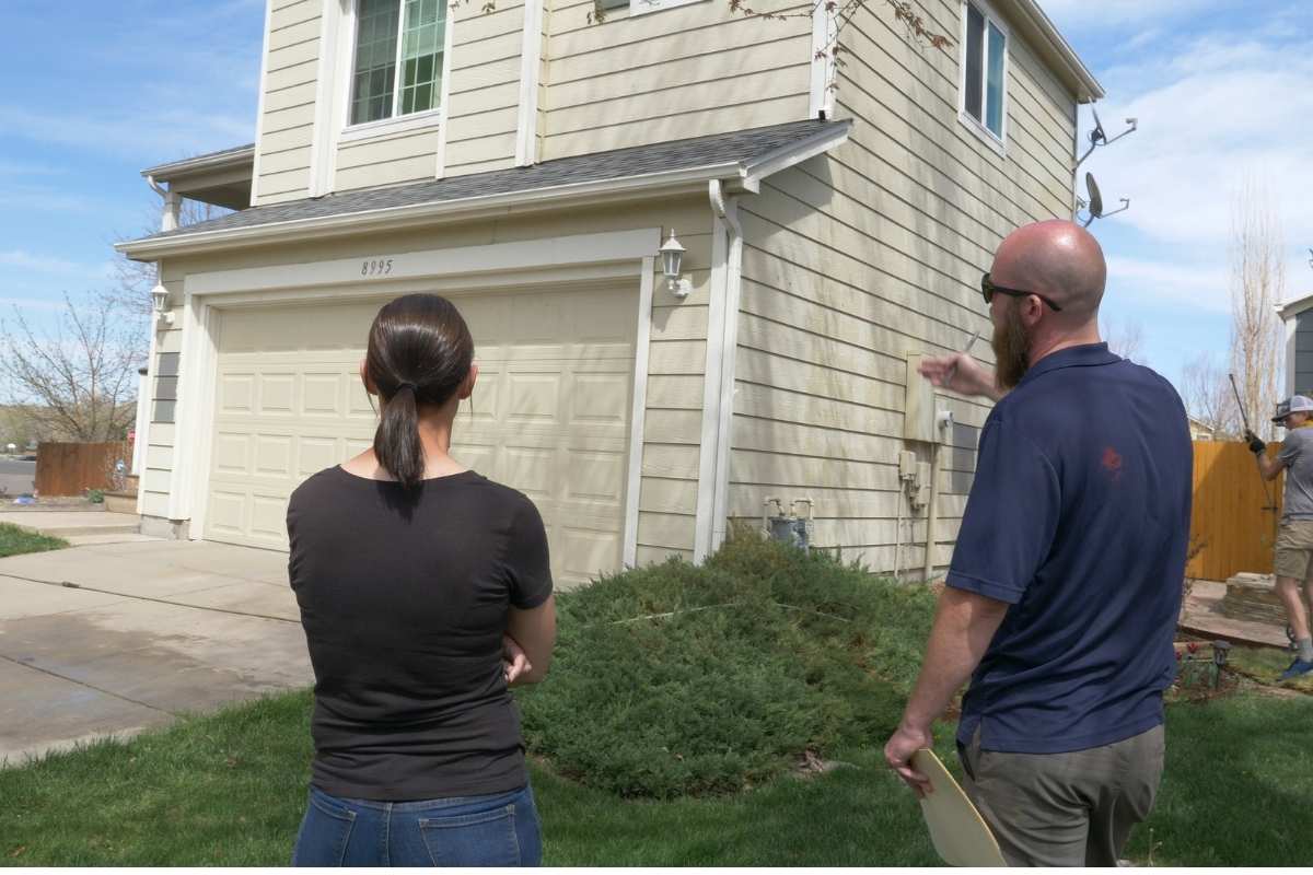 photo of kind home employee talking with home owner before painting