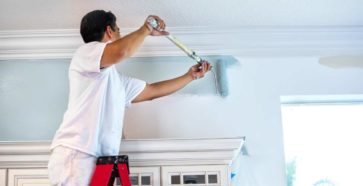 Paint Contractor Painting Wall using Rollers - Kind Home Solutions