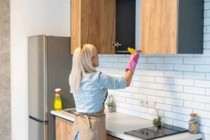 cleaning a kitchen cabinet