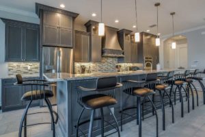 photo of kitchen with dark gray cabinets and light blue walls