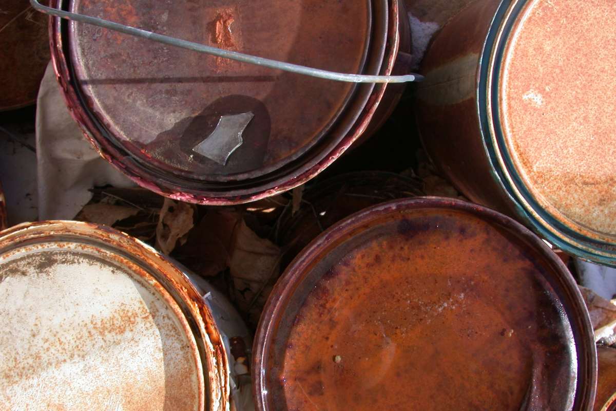 image of rusted paint cans stored improperly 